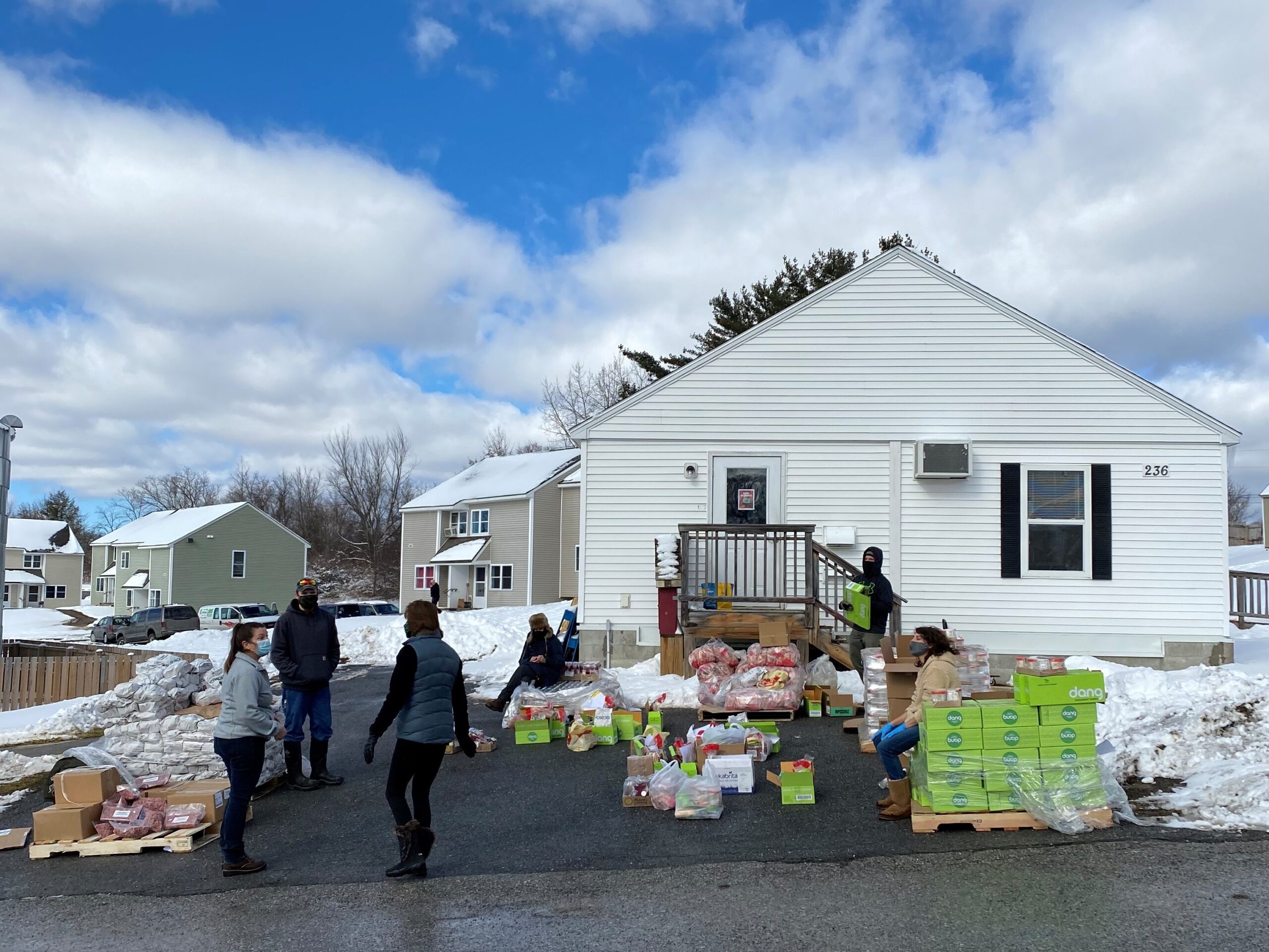 Shires' staff distributes food at Orchard Village February food drop